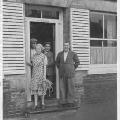 Customers on the step of the New Inn On the steps of The New Inn (now the Izaak Walton), customers keep their feet dry. Note 'Alton Ales'.