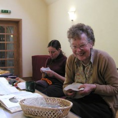Two embroiders Monique Aldridge and Sylvia Brindley. A team of over 30 embroiderers started work on the tapestry which was to include 107 houses and the fully embroidered borders which incorporate 26 birds, animals and church features.
