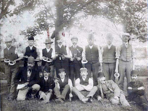 Unidentified men in team photograph. They appear to be holding wooden quoits.