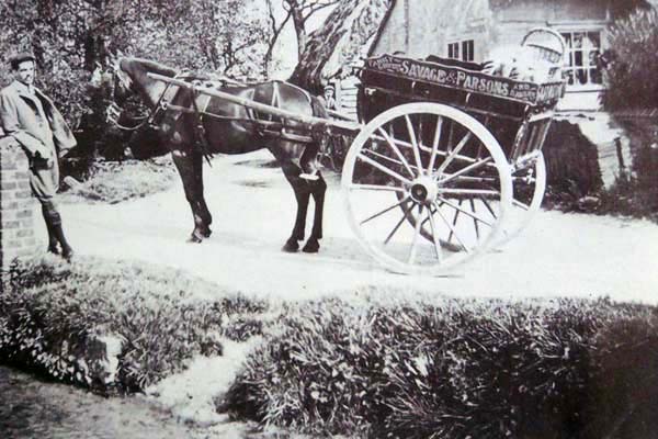 Savage and Parsons, later Parsons, was the largest and most popular shop in the High Street. Here, its delivery cart is seen in Frogmore.Charlie Merritt is the boy leaning agaiinst the bridge.