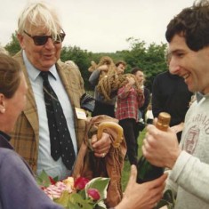 Grahame Davenport receives bottle of champagne from Susan, John Simpson looking on On the left, Susan Davenport and, centre, John Simpson, then chair of the Village Hall Committee, were the two responsible for the re-launch of the fete as a full-blown Country Fair. (Susan's husband Graham is receiving the bottle of champagne.)