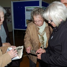 Ladies discussing photos Ladies discussing the photos they have brought for archiving.