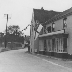 Man erecting Royal Navy Ensign on Country StoreMan erecting Royal Navy Ensign on Country Store Man erecting Royal Navy Ensign on Country Store.