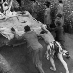 Men pushing Berry family lorry during fancy dress parade. Men pushing Berry family lorry during fancy dress parade.
