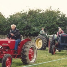 Tractor parade Parade of vintage tractors at an early Country Fair.