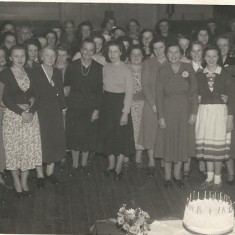 Large gathering at the old Village Institute. Marion Lambert, Bridget's mother, is in the crowd .