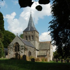 All Saints through trees The churchyard of All Saints | Michael Blakstad