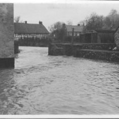 Flood across bridge and beamed cottages Flood across bridge and beamed cottages, possibly car park at New Inn. Collection of '50s photos at Ye Olde George.
