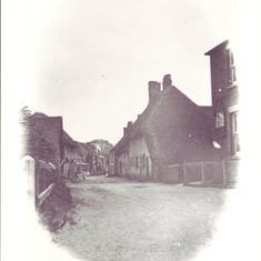 Vignette of High Street looking east. This photo was taken from outside what is now East Meon Stores and was then Aburrow's wheelwright workshop. The Institute can be seen on the right,, then Barnards Corner. On the left, Glenthorne House in the distance.