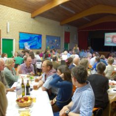 Race Evening in Village Hall Dinner wit horse races projected on screen. | Michael Blakstad