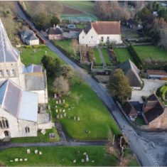 Aerial view of All Saints and Court House Drone photograph by showing the church and the church hall, barn, and the cottage, barn and gardens at The Court House | Richard Gaisford