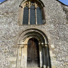 West door exterior and window above Romanesque arches and zig-zag beading on West Door.