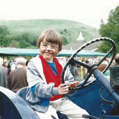 Boy, face painted, at tractor wheel Country Fair 1993 - 2000