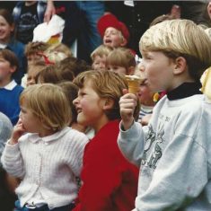 Kids watching, sucking lollies Kids watching arena display, sucking lollies
